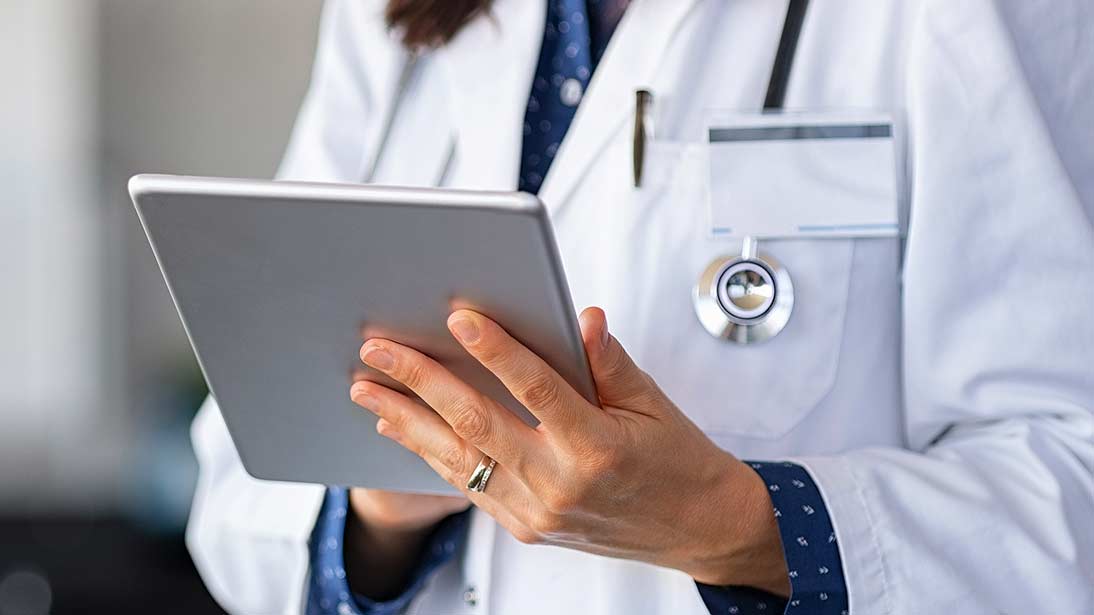 a healthcare professional with a tablet