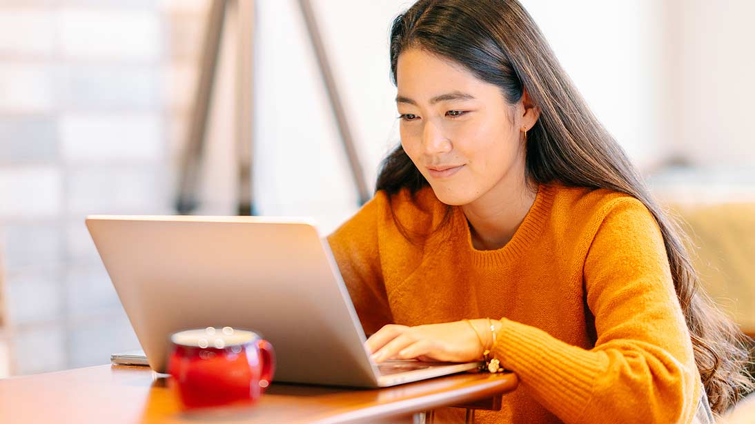 a professional working at her laptop